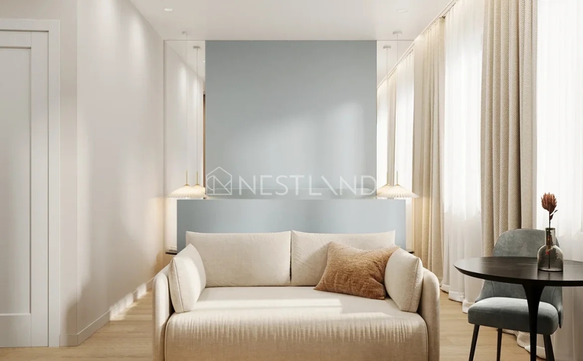 Modern living room with beige sofa, blue accent wall, and sheer curtains.