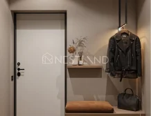 Modern entryway featuring a white door, leather jacket on a hanger, stylish bench, decorative vase, and shoes on a slatted shelf.