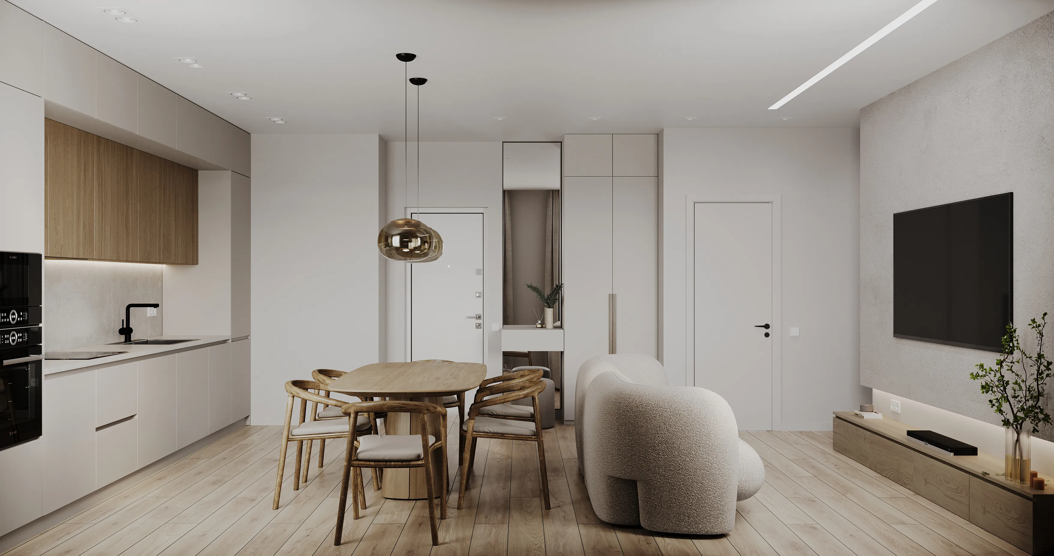 Open-plan kitchen and living room with white cabinets, light wood floors, and a round wooden dining table for six.
